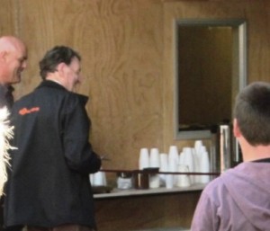 Wally Hawken (left) watches as John Gallagher cuts the ribbon to open Gallagher Base for the Raglan Coastguard