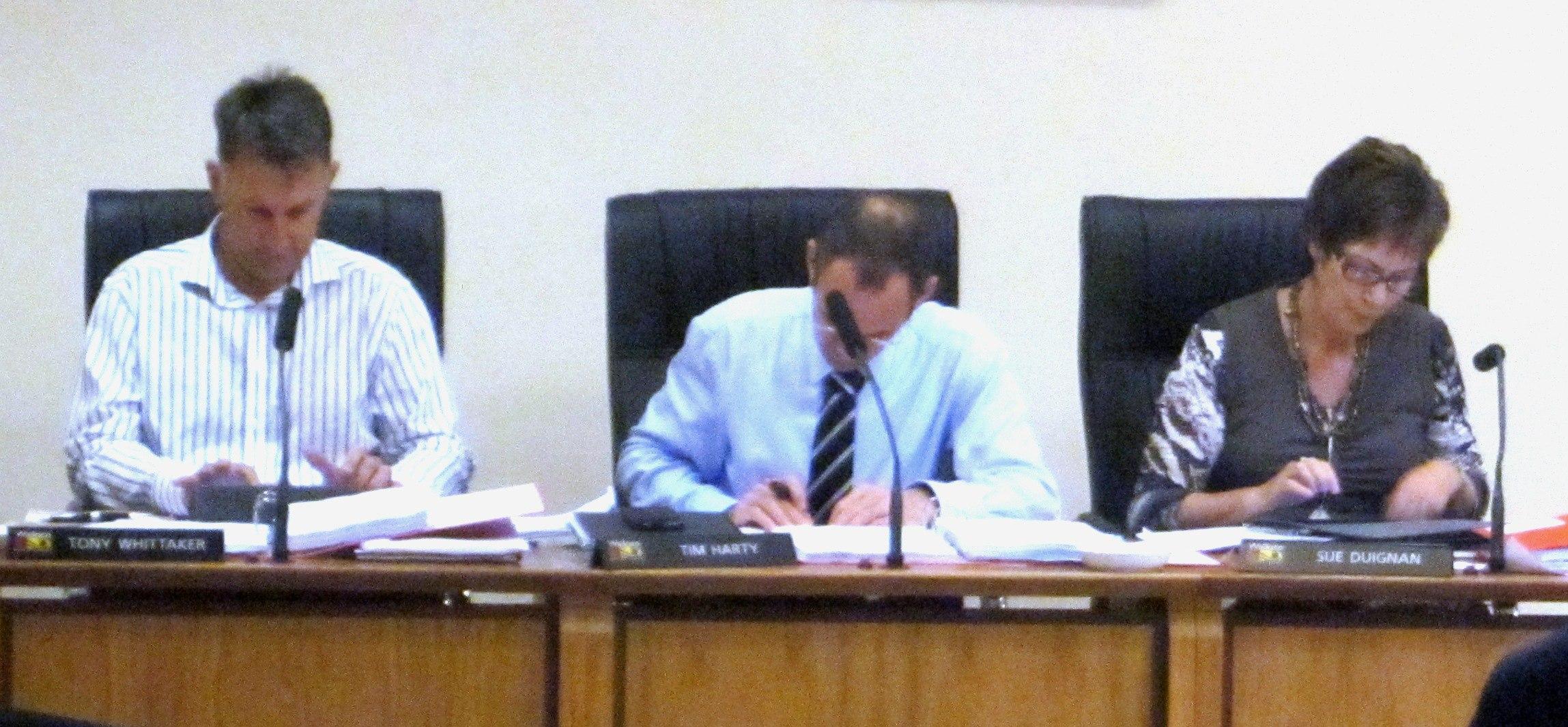 The three Council GMs all busy with their iPads during the submission hearings