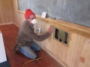 Chris Mitchell does some delicate hand sanding around the heritage ventilation aperture