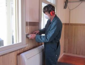 James removes some of the final patches of paint from the walls.