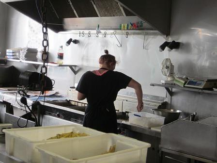 Staff members cooks up some fish 'n chips at Raglan Fish
