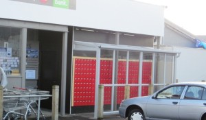 Aluminium window lean-to protecting the postal boxes from rain