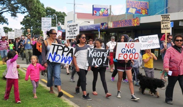 Marchers head up Bow St with banners protesting against the TPPA