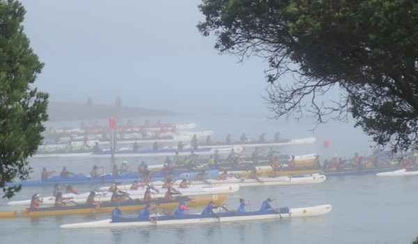 Waka emerge from the mist as they leave the Opotoru Estuary