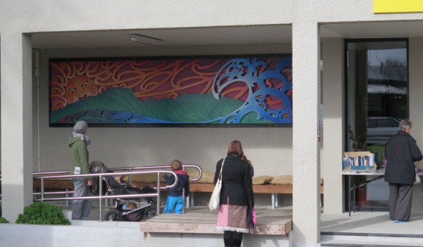 Residents studying and admiring the mural on Friday