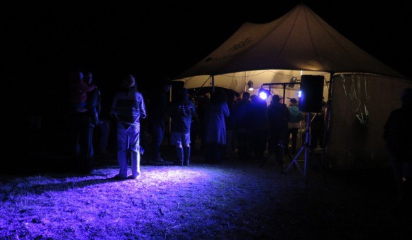 People sample the kai in the marquee before the bonfire