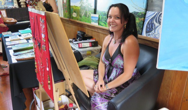 Rickie Hill works on a painting at the Old School