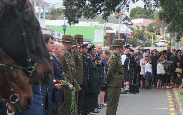 Horses, services and community line Bow Street during the commemoration