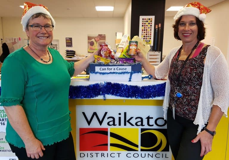 Melanie Hunkin, left, and Jane Macartney at Waikato District Council’s Tuakau office with a small portion of the Council’s Cans for a Cause collection.