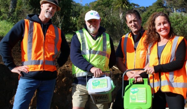 Xtreme Zero Waste Relationship Manager Rick Thorpe, left, with Raglan Community Board Chairman Bob McLeod holding a kitchen caddy. Xtreme Zero Waste Operations Manager Cain Brodie holds a kerbside foodwaste bin flanked by Raglan Ward Councillor Lisa Thomson. Image supplied