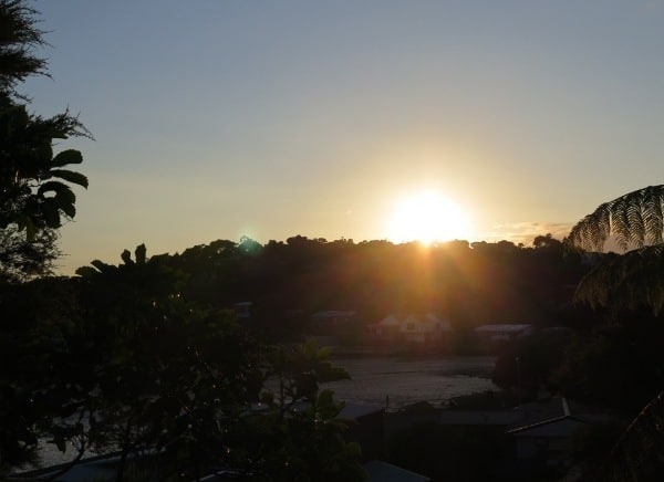 The first rays of the Christmas Day sun shine from above Greenslade Road lighting up Raglan's Lorenzen Bay