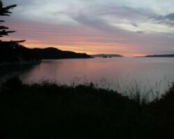Aotea Harbour with small islands (Motukotuku Rocks) in the middle distance. 160121aoteabymoonlight