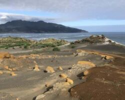View from Te Kaha Point of harbour, coast, sand dunes, mountain and Raglan.